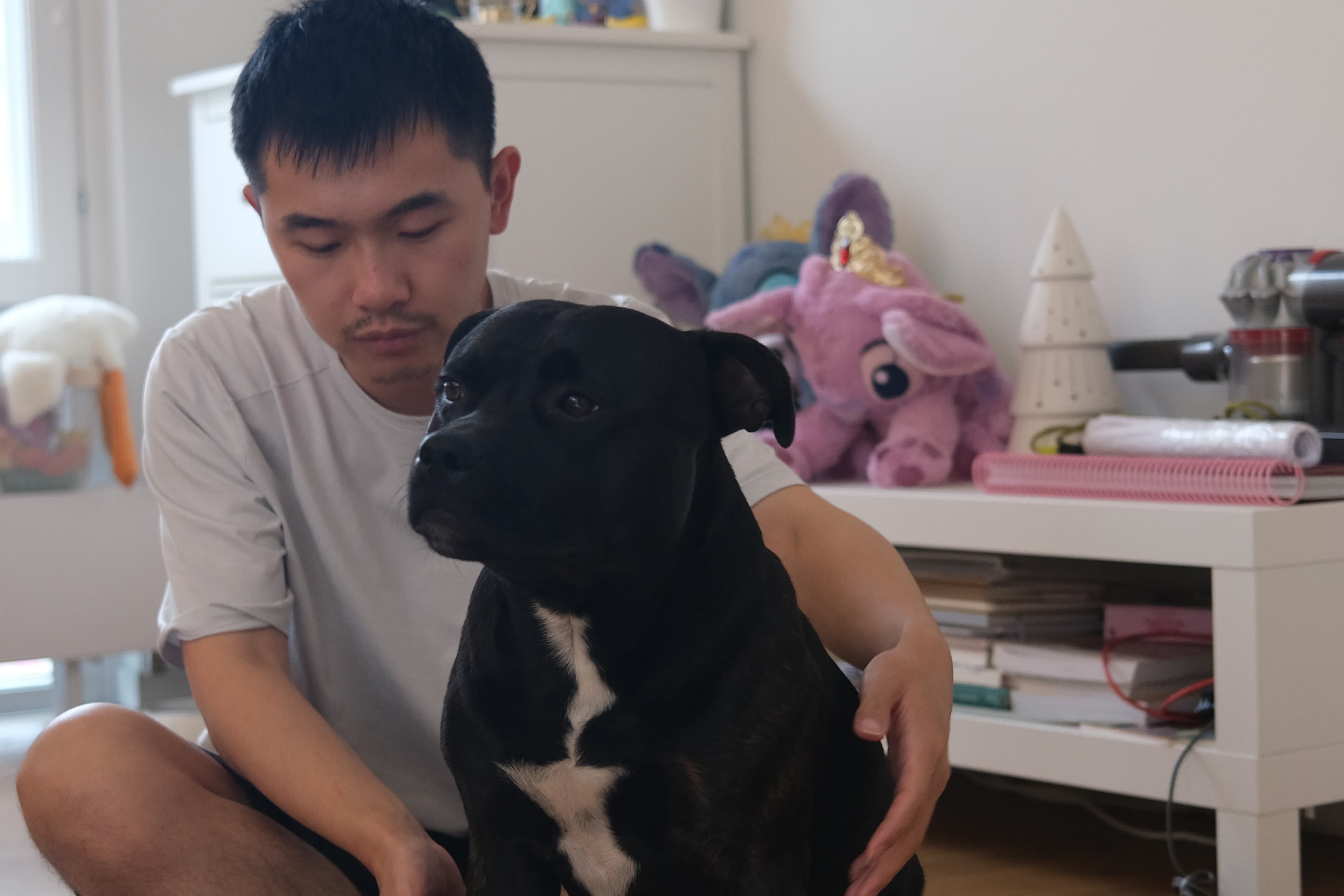 Evan sitting calmly with Aston during an indoor care moment