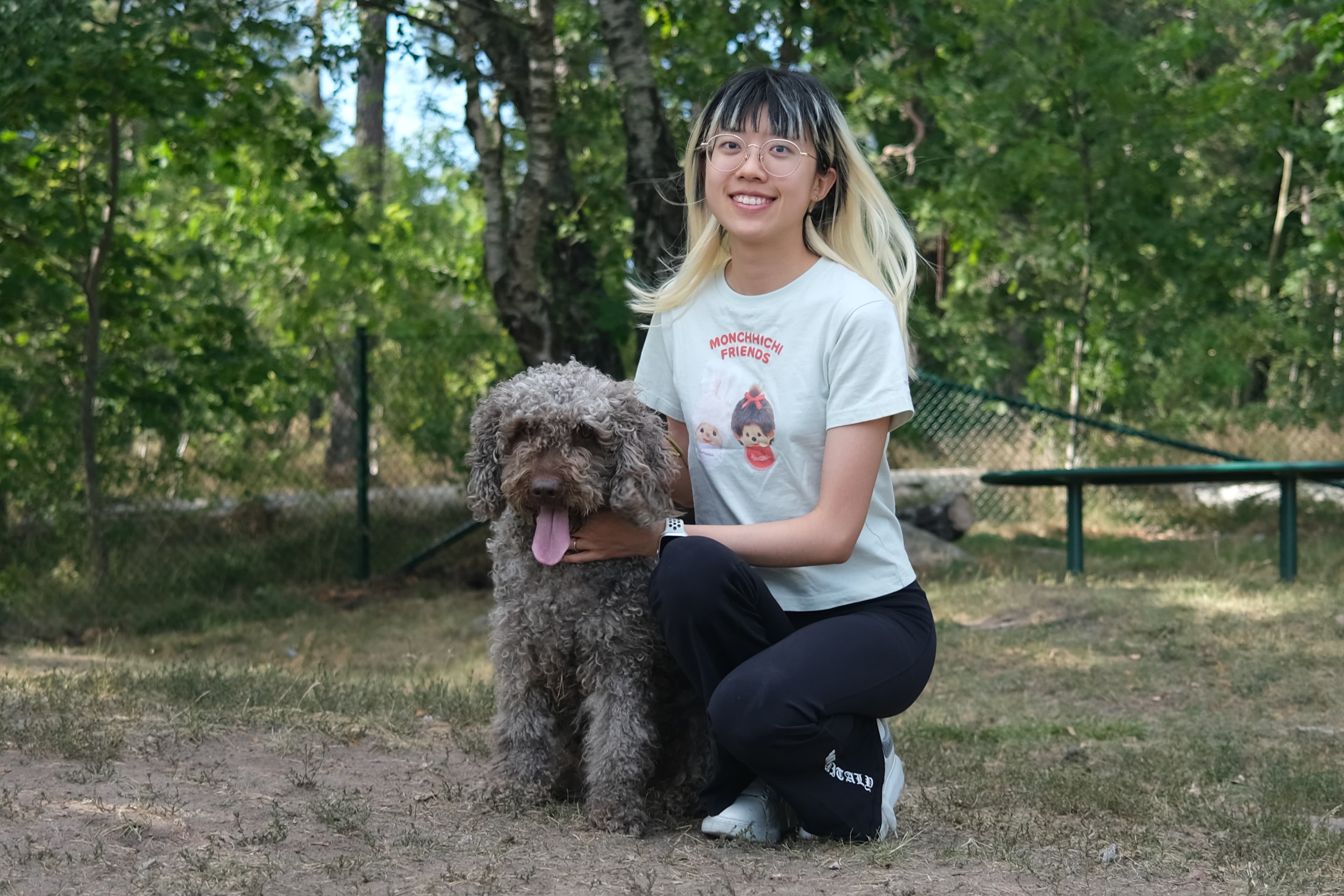 Zoe kneeling beside Jum Jum outdoors